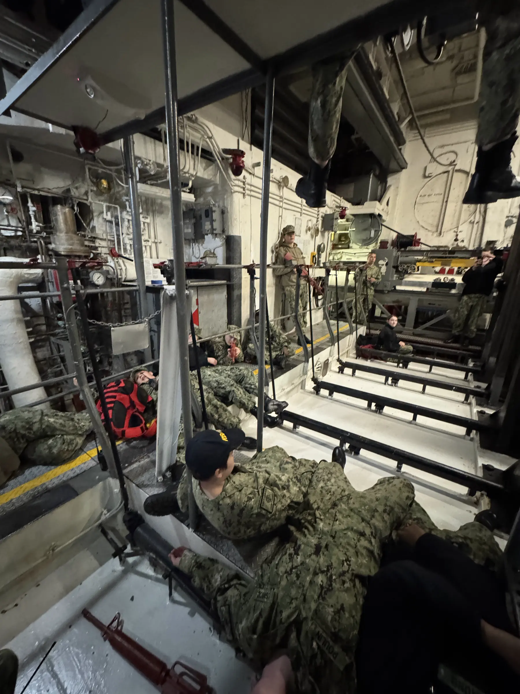 Cadets working in a ship's engineering space during training