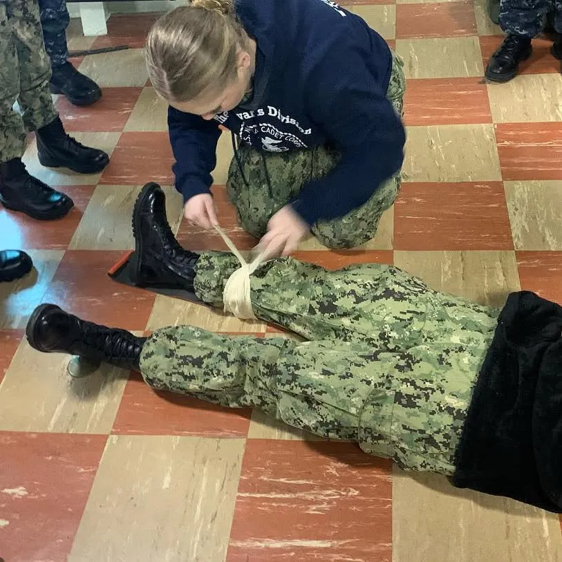 Cadet practicing first aid and bandaging techniques