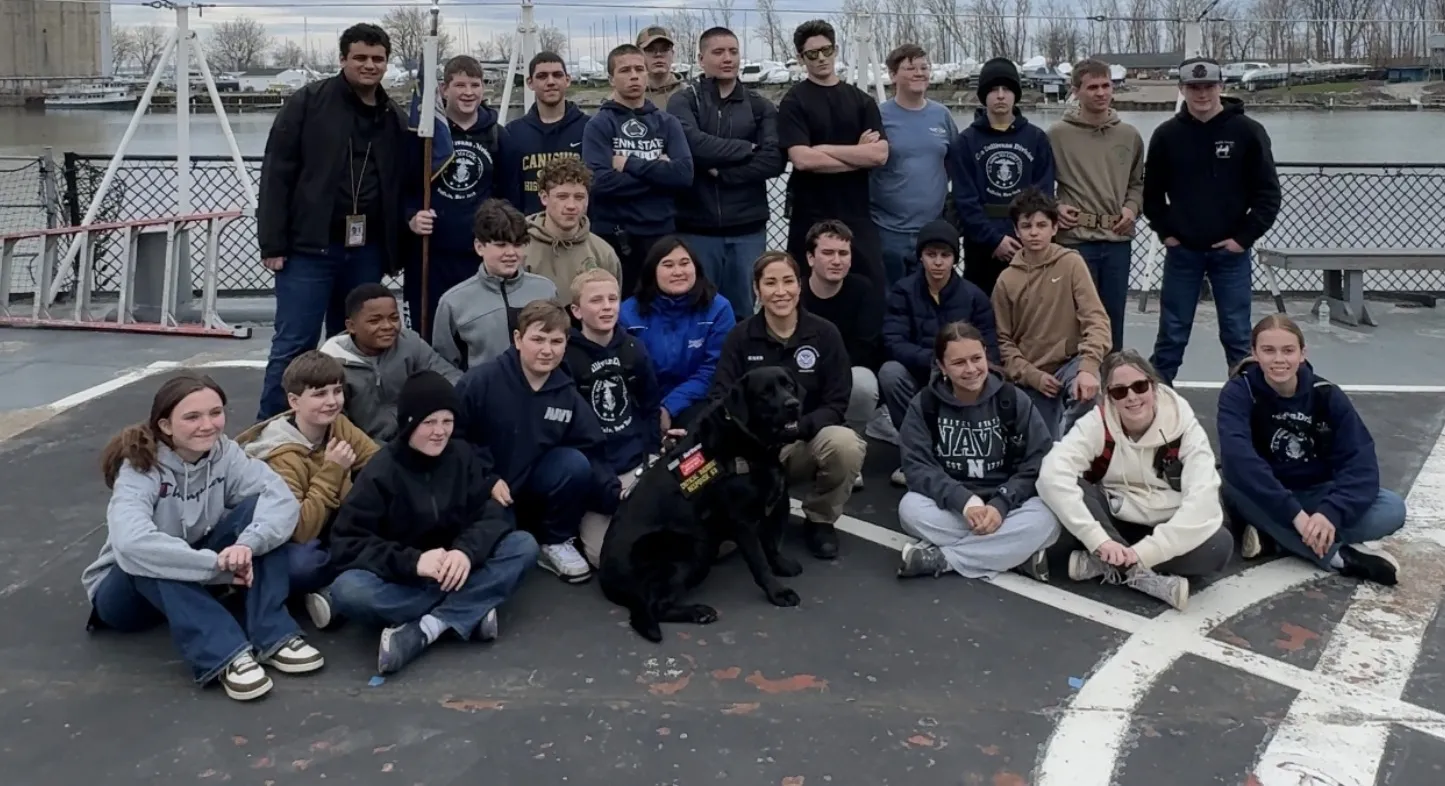 Cadets and staff of The Sullivans Division gathered on deck at the end of a drill weekend, with the unit dog.